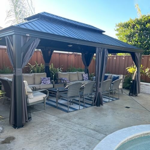 Outdoor patio with gazebo, seating, and poolside view