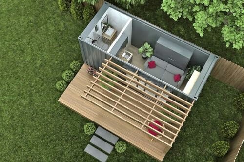Aerial view of a small container home with a wooden deck and pergola, surrounded by greenery.
