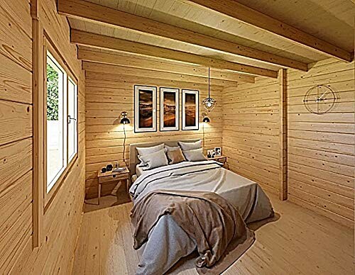 Cozy wooden bedroom with bed, wall art, and natural light.