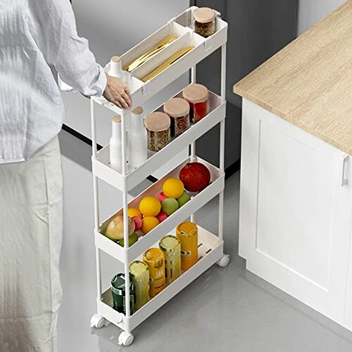 Person using a slim rolling kitchen storage cart with shelves for bottles and jars.
